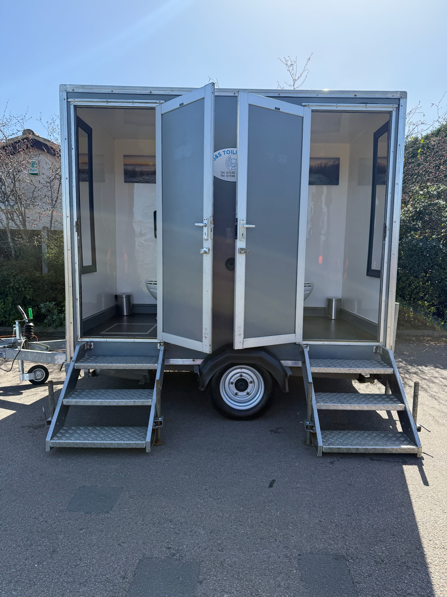 Luxury toilet trailer with doors open showing interior compartments