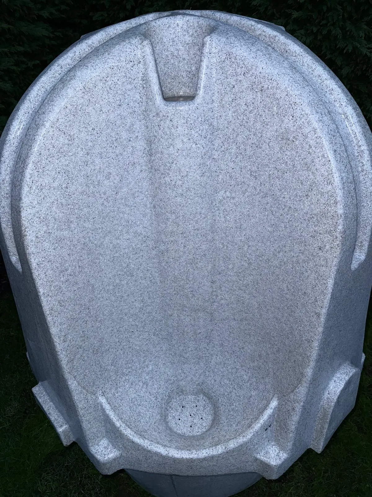 Top-down view of a grey portable urinal unit (alternative angle)