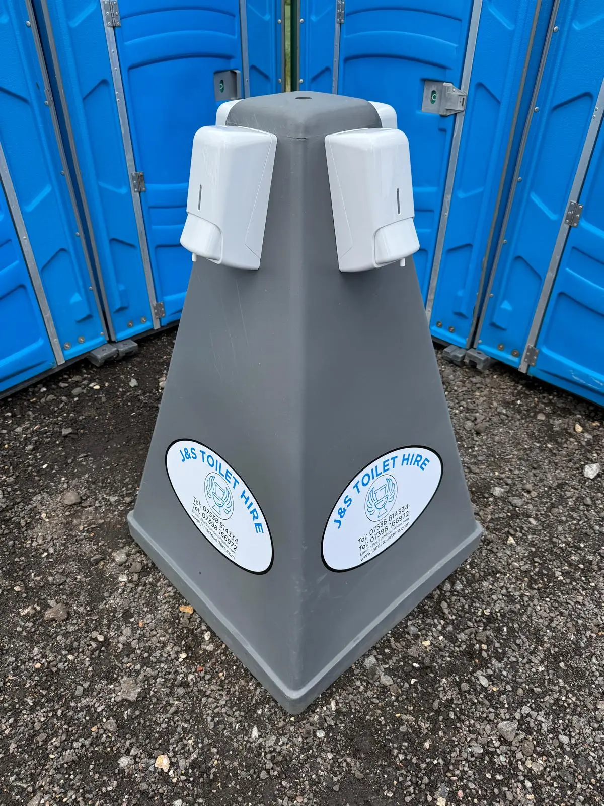 Close-up of the wash station with J&S Toilet Hire branding