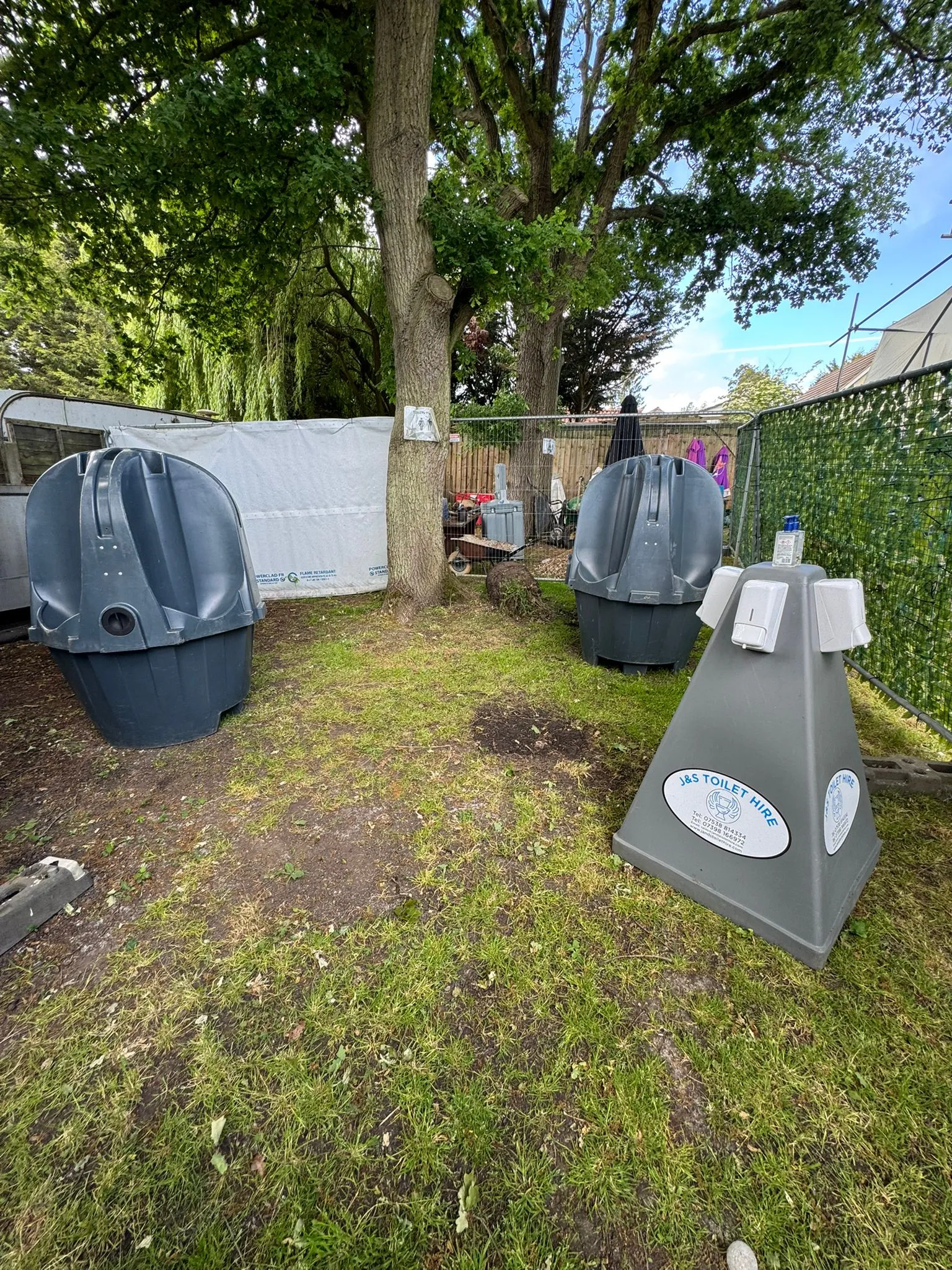 Wash station and urinals in an outdoor, grassy event setting