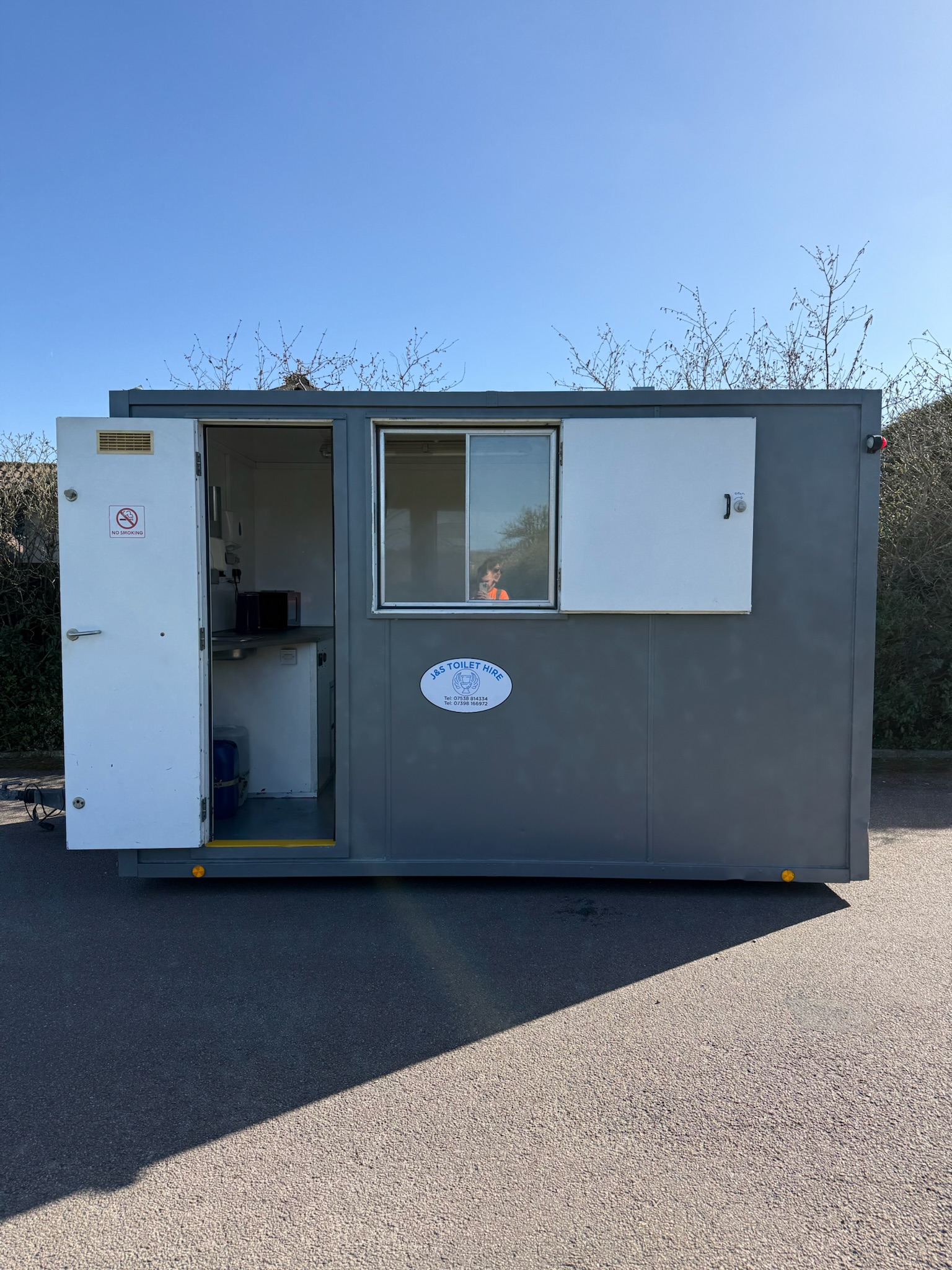 Welfare unit exterior - front view with door open showing interior