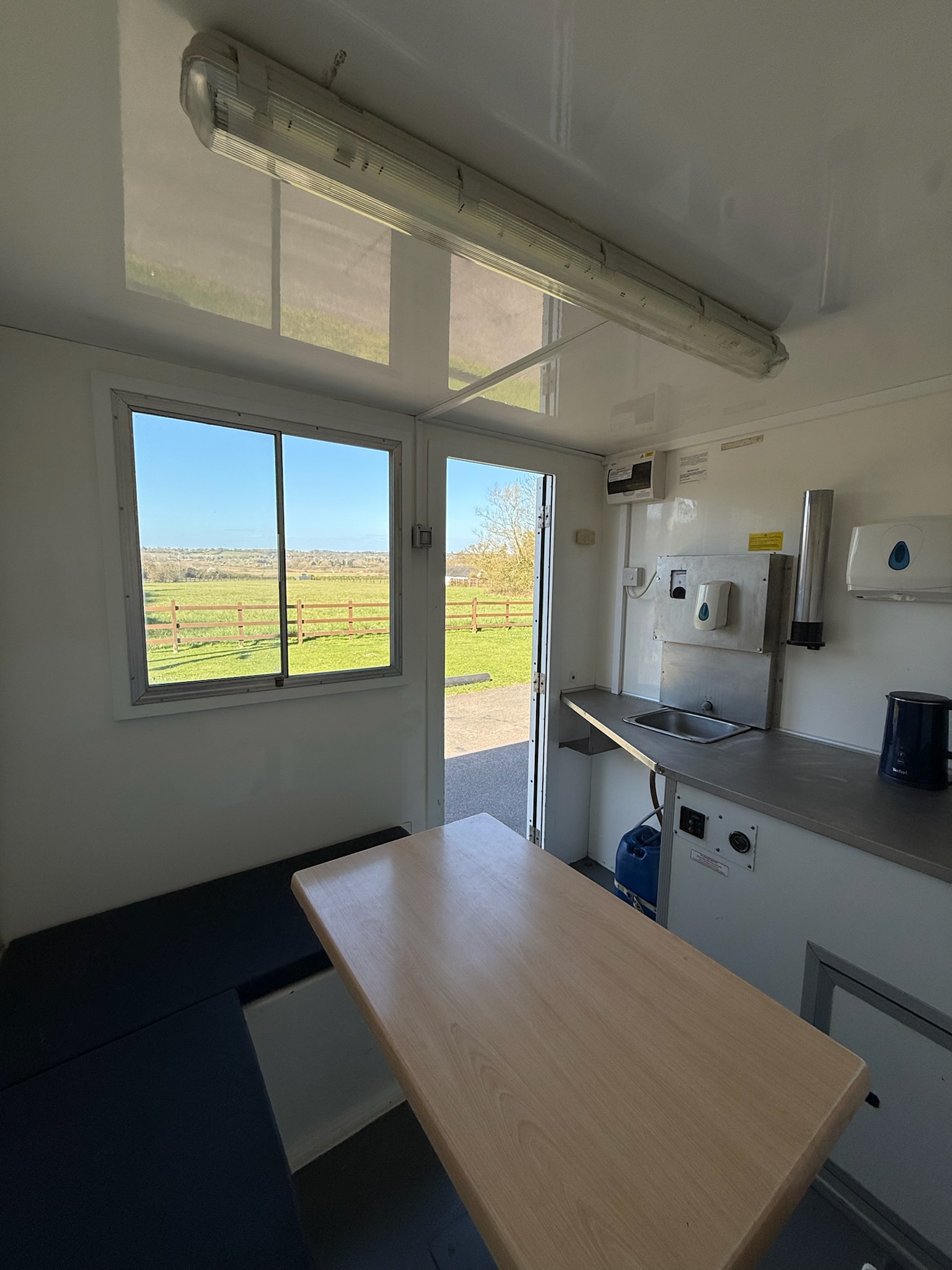 Welfare unit interior - kitchen area with countryside view through window